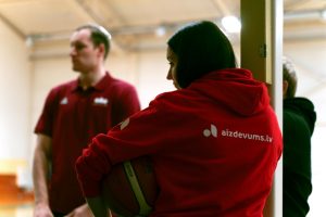 Meitene tur rokās basketbola bumbu